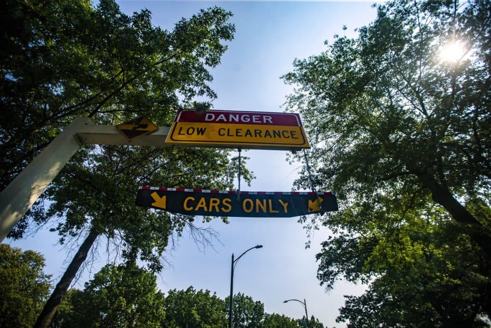 A hanging “Cars Only” sign on University Road warning drivers of the low clearence on Storrow Drive. (Jesse Costa/WBUR)