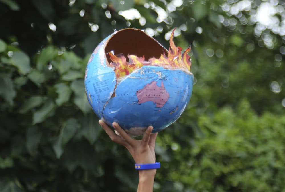 A girl holds a globe as she participates in a protest calling for action against climate change in Mumbai, India, Friday, Sept. 27, 2019. (Rafiq Maqbool/AP)