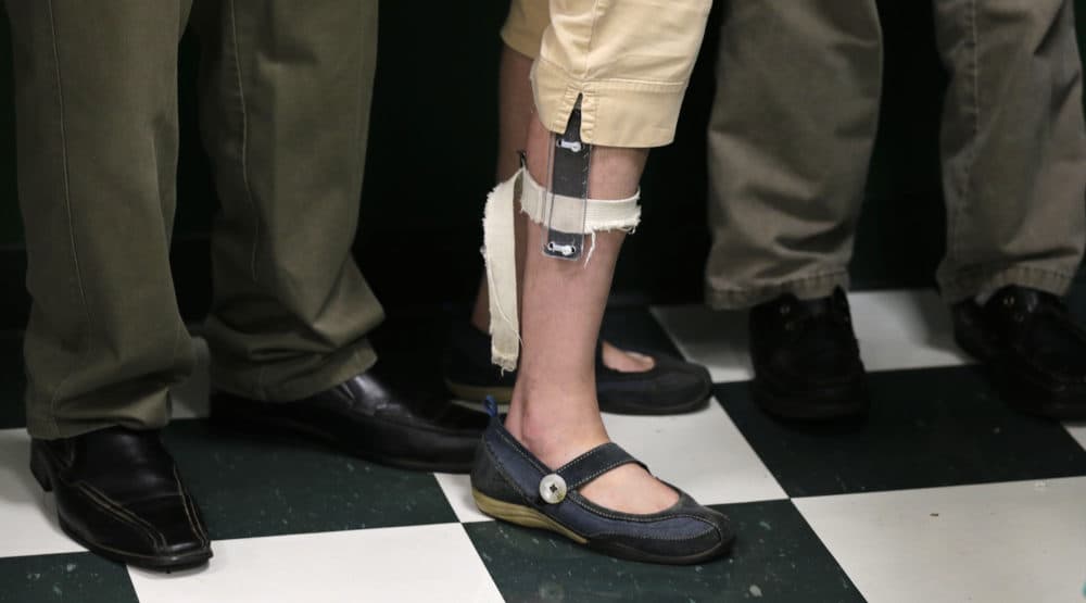 In this Aug. 13, 2014 photo, a student wearing an electrical shocker device on her leg lines up with her classmates after lunch at the Judge Rotenberg Educational Center in Canton, Mass. (Charles Krupa/AP)