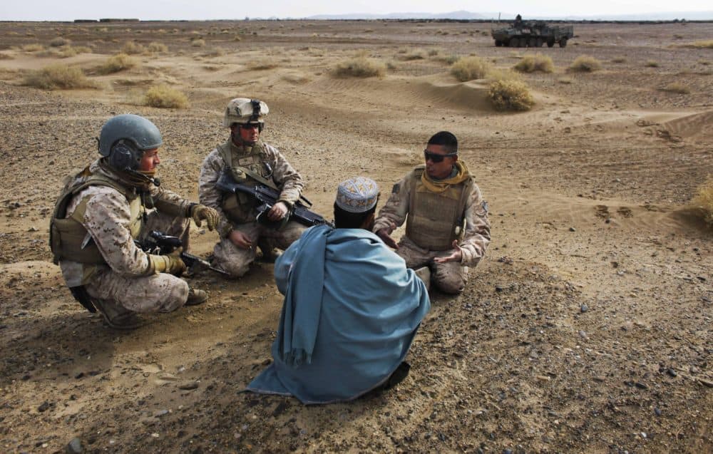 Dec. 11, 2009: United States Marine Sgt. Isaac Tate (left) and Cpl. Aleksander Aleksandrov (center) interview a local Afghan man with the help of a translator from the 2nd MEB, 4th Light Armored Reconnaissance Battalion on a patrol in the volatile Helmand province of southern Afghanistan. (Kevin Frayer/AP/File)