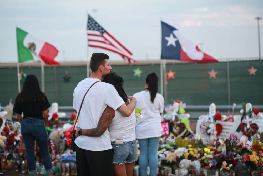 People gather at a makeshift memorial honoring victims outside Walmart on August 15, 2019 in El Paso, Texas. Twenty-two people were killed in the Walmart during a mass shooting on August 3. (Sandy Huffaker/Getty Images)