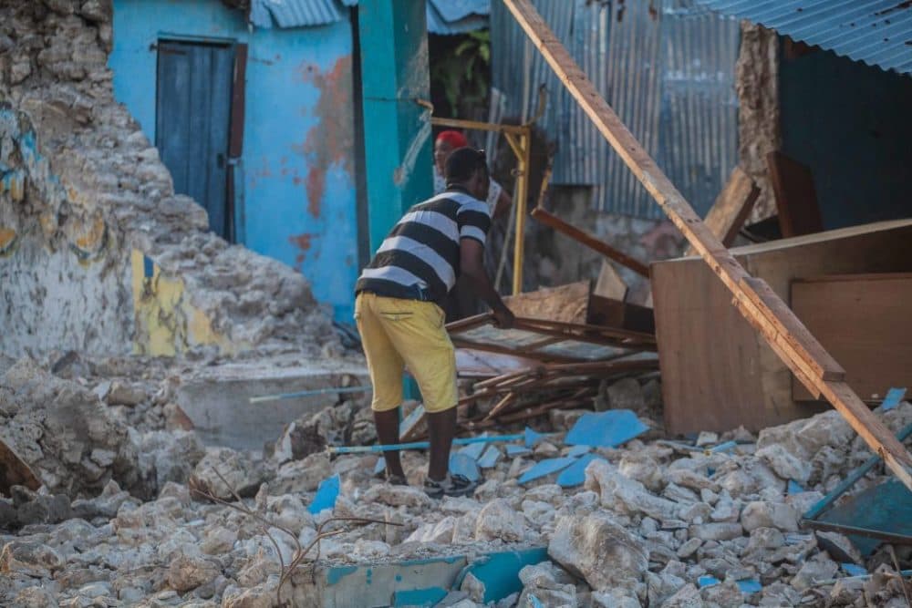 A man recovers what he can after a 7.2-magnitude earthquake struck Haiti. (Richard Pierrin/Getty Images)