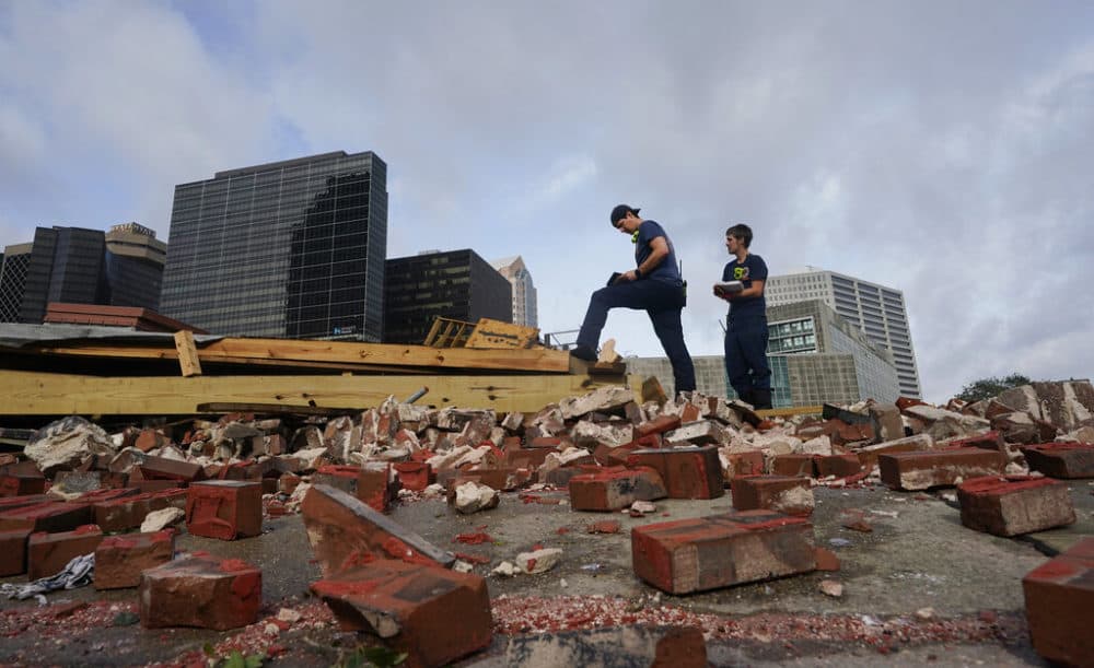 New Orleans Firefighters assess damage as they look through debris after a building collapsed from the effects of Hurricane Ida, Monday, Aug. 30, 2021, in New Orleans, La. All of New Orleans lost power right around sunset Sunday as the hurricane blew ashore on the 16th anniversary of Katrina. (Eric Gay/AP)