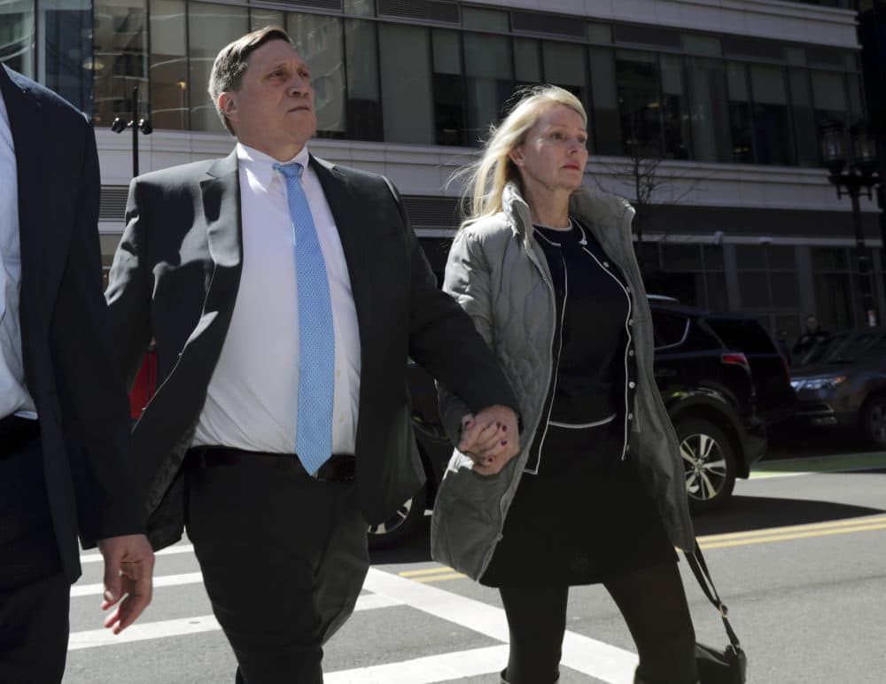 In this April 3, 2019 file photo, investor John Wilson, left, arrives at federal court in Boston with his wife Leslie to face charges in a nationwide college admissions bribery scandal. (Charles Krupa/AP File)