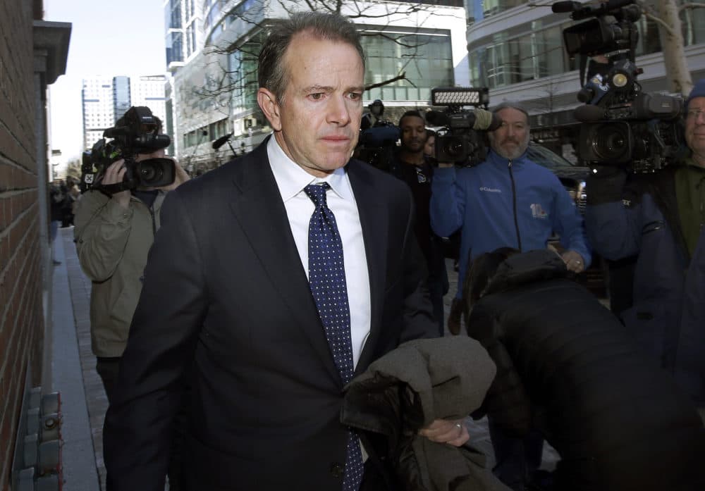 In this March 25, 2019 file photo, Gordon Ernst, former Georgetown tennis coach, departs federal court in Boston after facing charges in a nationwide college admissions bribery scandal. Ernst, accused of accepting more than $2 million in bribes to help kids get into the school, will plead guilty in the sweeping college admissions scandal, according to court documents filed Wednesday, Sept. 15, 2021. (Steven Senne / AP Photo)