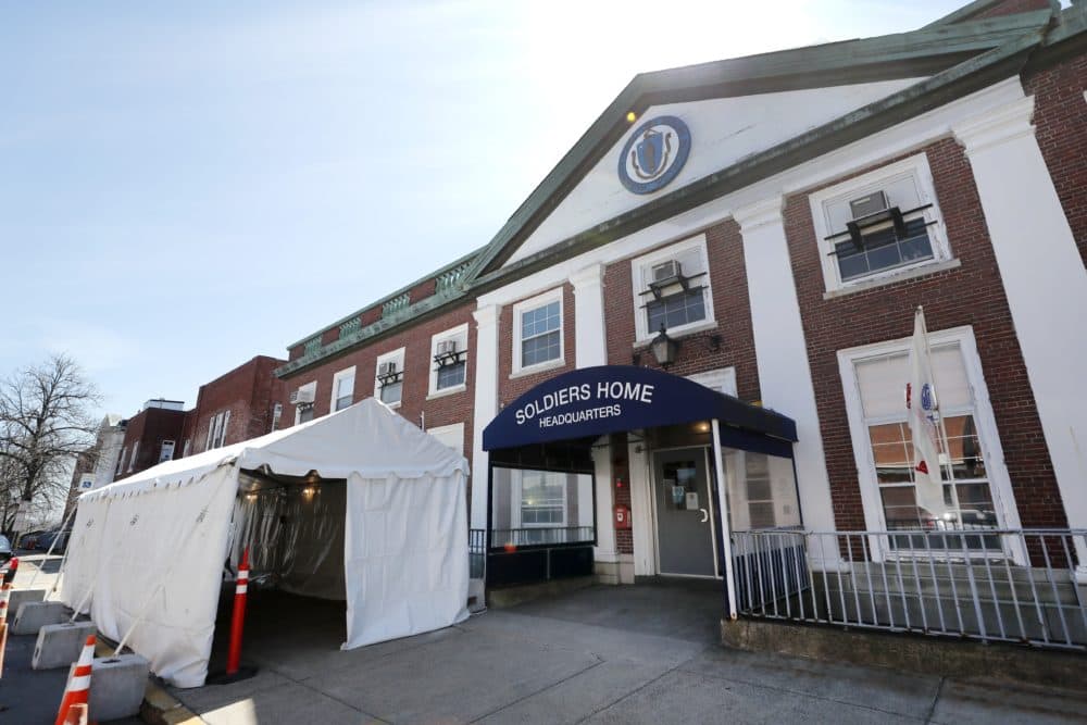 In this April 6, 2020, file photo, a tent is set up next to the entrance of the Soldiers' Home in Chelsea, Mass. Families of veterans who died in one of the deadliest COVID-19 outbreaks in a nursing home in the country are calling for changes in how Massachusetts oversees its veterans homes. (Elise Amendola/AP File)