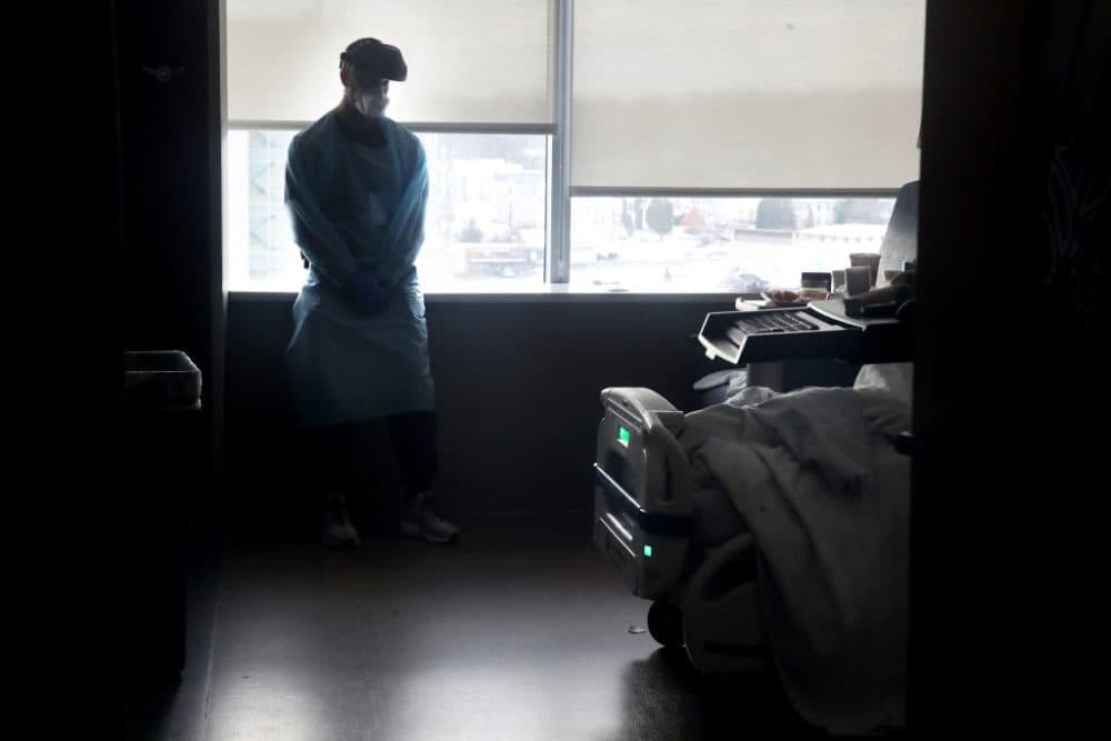 Physicians assistant Brendan Smith cares for a patient in a COVID unit at UMass Memorial Medical Center in Worcester, Mass. on December 10, 2020.  (Craig F. Walker/The Boston Globe via Getty Images)