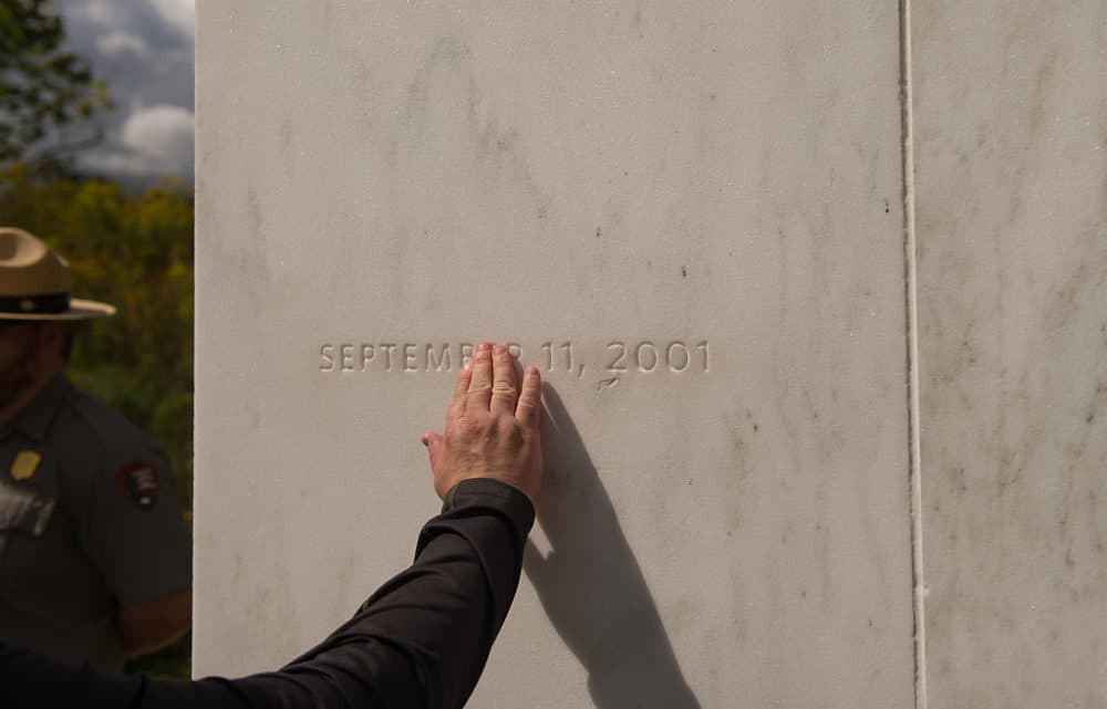 visitor traces the date etched in a marble slab on the Wall of Names at the Flight 93 National Memorial in Shanksville, Pa., in 2016. United Airlines Flight 93 crashed into a field outside Shanksville, Pa., with 40 passengers and four hijackers aboard on Sept. 11, 2001. (Jeff Swensen/Getty Images)