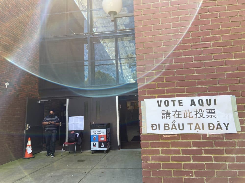 Outside the Shelburne Community Center in Roxbury on Saturday, September 4 — the start of early voting for Boston residents. The sign reads &quot;vote here.&quot; (Quincy Walters/WBUR)