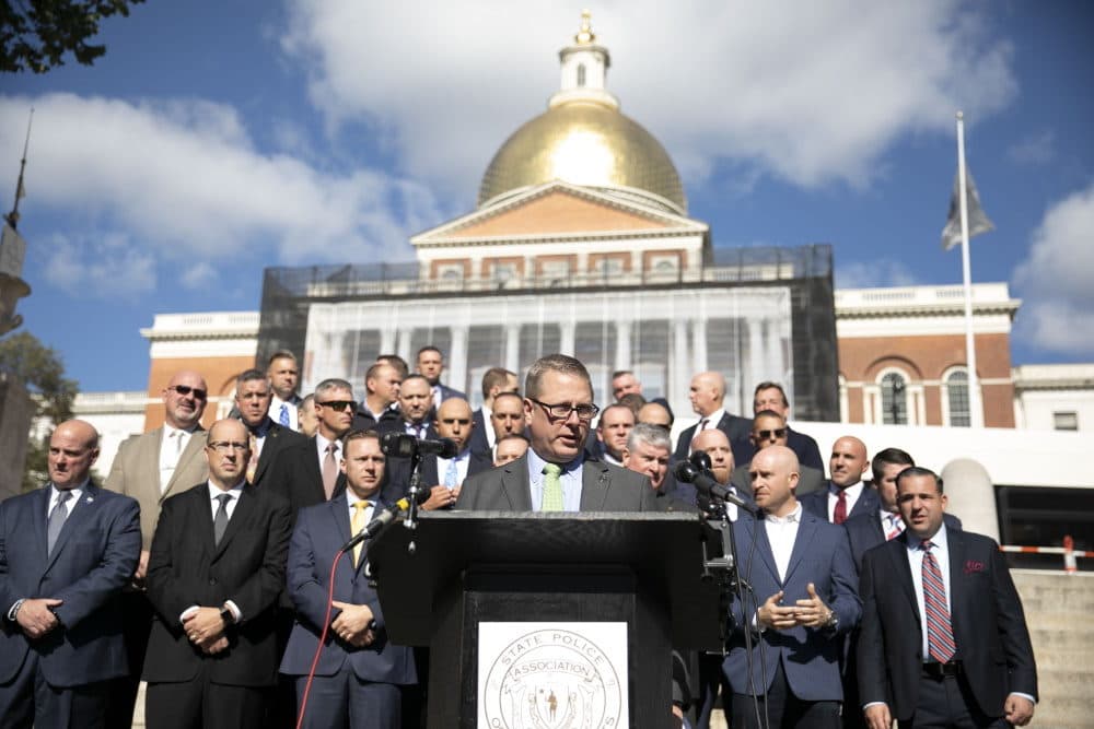 Flanked by Massachusetts state troopers and officers from other states, State Police Association of Massachusetts President Michael Cherven speaks to reporters on Boston Common about the Baker administration's vaccine mandate on Monday. (Chris Lisinski/SHNS)