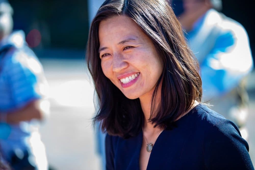 Boston mayoral candidate Michelle Wu greets with supporters at Readville Station in Hyde Park. (Jesse Costa/WBUR)