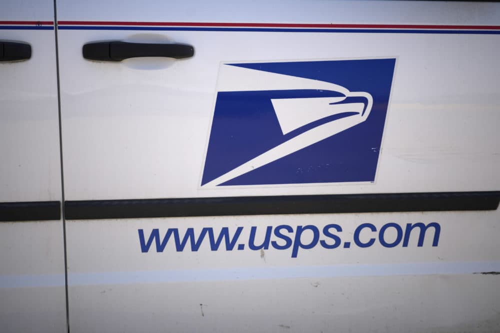 The United States Postal Service logo on the side of a mail delivery van. (David Zalubowski/AP)