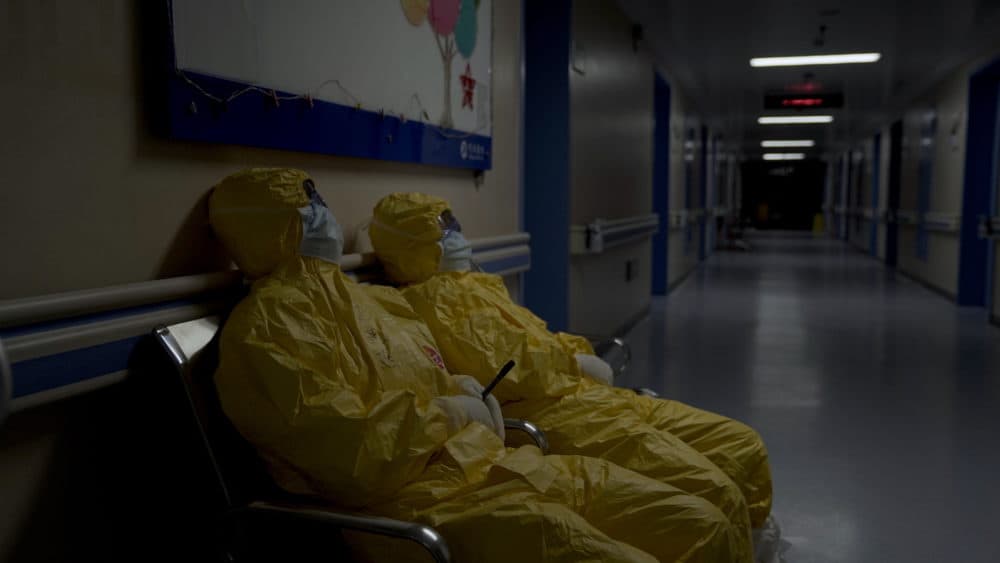 Nurses collapse from exhaustion in a hospital hallway during the peak of the COVID-19 outbreak in Wuhan, China. Seen in &quot;76 Days.&quot; (MTV Documentary Films)