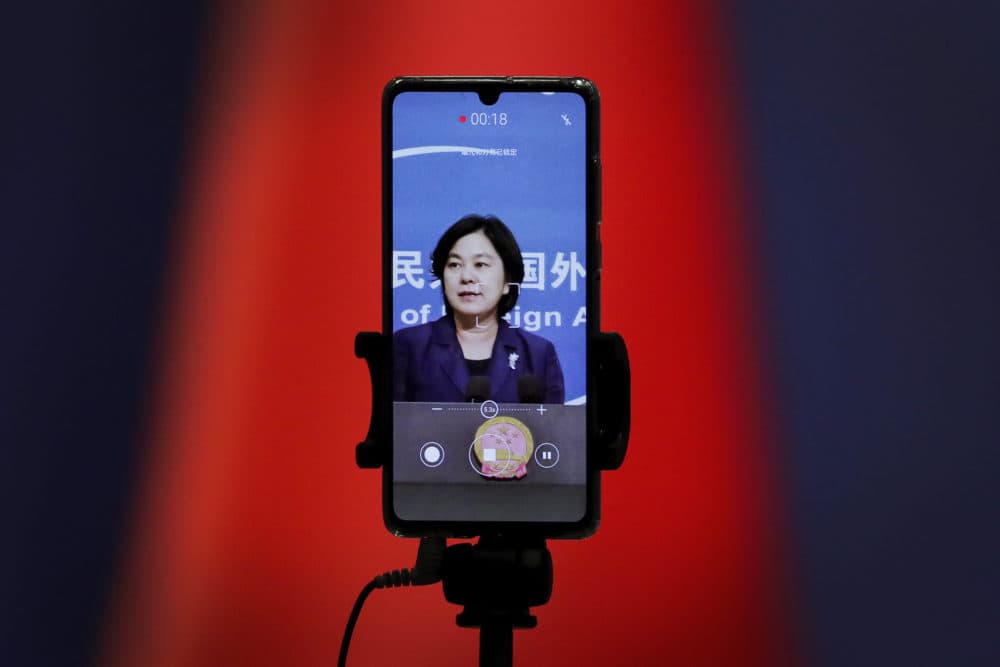 A smartphone records Chinese Foreign Ministry spokeswoman Hua Chunying as she speaks during a daily briefing at the Ministry of Foreign Affairs in Beijing. &quot;I'd like to stress that if the United States truly respects facts, it should open the biological lab at Fort Detrick, give more transparency to issues like its 200-plus overseas bio-labs, invite WHO experts to conduct origin-tracing in the United States,&quot; she said at a January 2021 MOFA press conference that went viral in China. (Andy Wong/AP)