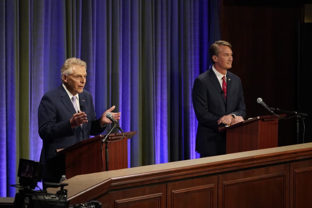 Democratic gubernatorial candidate and former Gov. Terry McAuliffe (left) gestures as his Republican challenger, Glenn Youngkin, looks on during a debate at the Appalachian School of Law in Grundy, Va., on Sept. 16, 2021. (Steve Helber/AP)