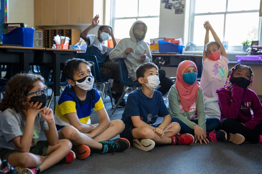 Students listen to their teacher read them a story at Samuel W. Tucker Elementary School in Alexandria, Virginia, on Thursday, August 19, 2021. (Amanda Andrade-Rhoades/Getty Images)