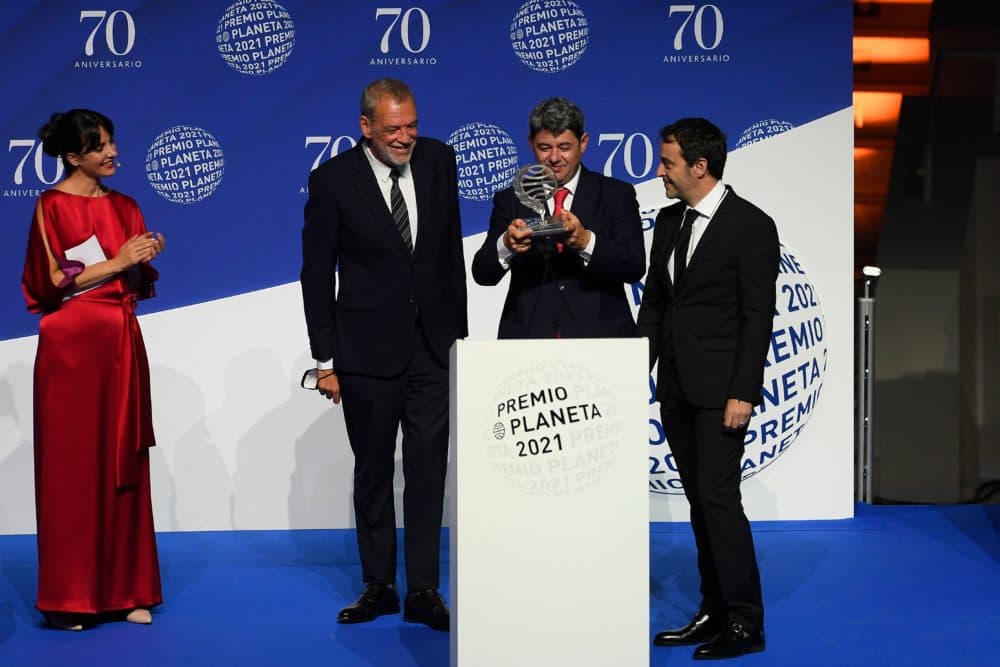 (From 2nd-L) Winners of Spain's 2021 Premio Planeta award Jorge Diaz, Antonio Mercero and Augustin Martinez receive the trophy for their novel &quot;La Bestia&quot;, written under the pseudonym Carmen Mola during the ceremony of the 70th edition of the &quot;Premio Planeta&quot; award, in Barcelona on Oct. 15, 2021. (Josep Lago/AFP via Getty Images)