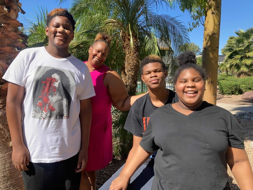 Shuntera Brown and her kids outside their new apartment in Phoenix. The family was evicted in July after they got COVID-19 and Brown was unable to work. (Peter O'Dowd/Here & Now)