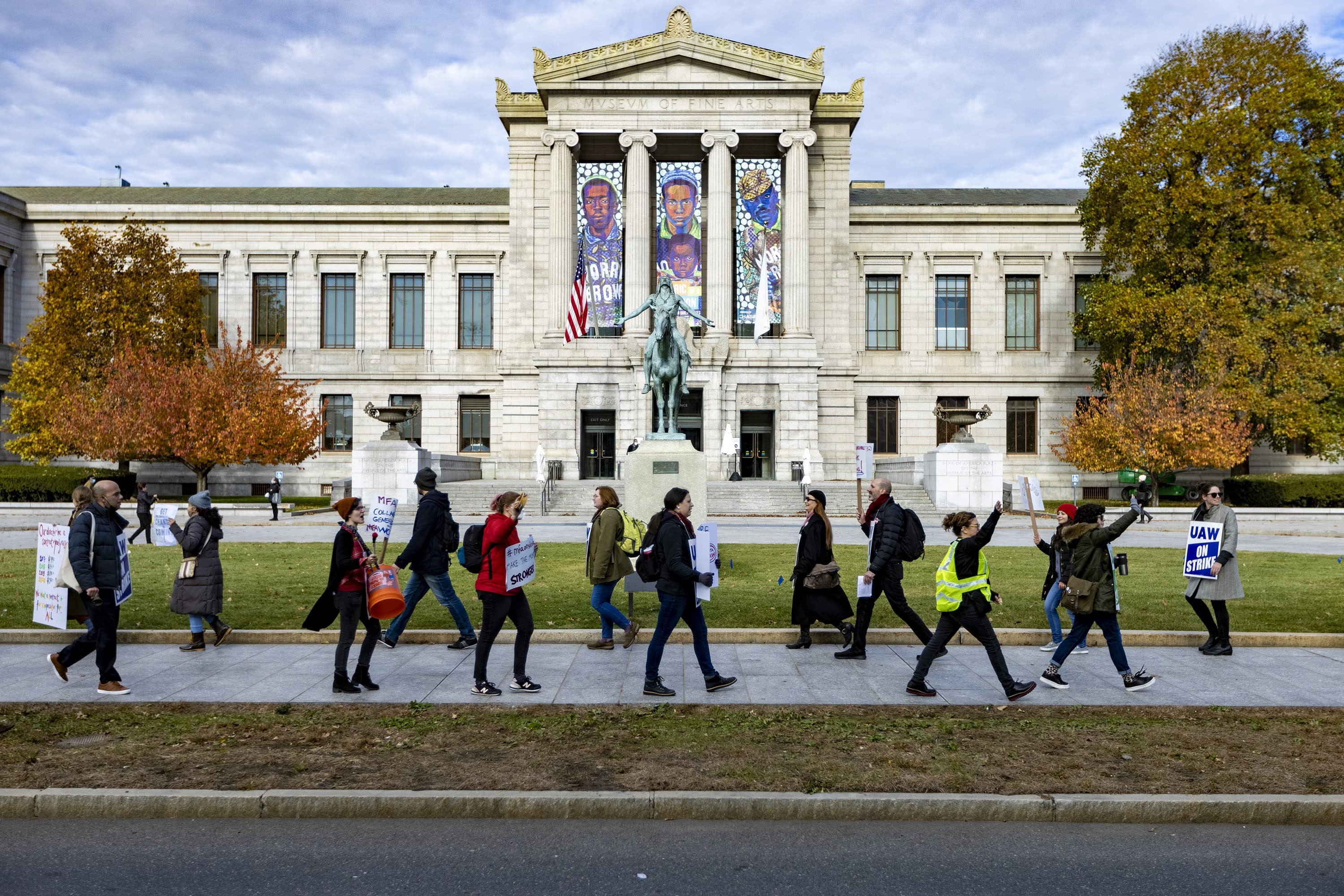 Museum staff and their supporters picket outside of the front entrance of the Museum of Fine Arts on Huntington Avenue demanding livable wages and decent working conditions. (Jesse Costa/WBUR)