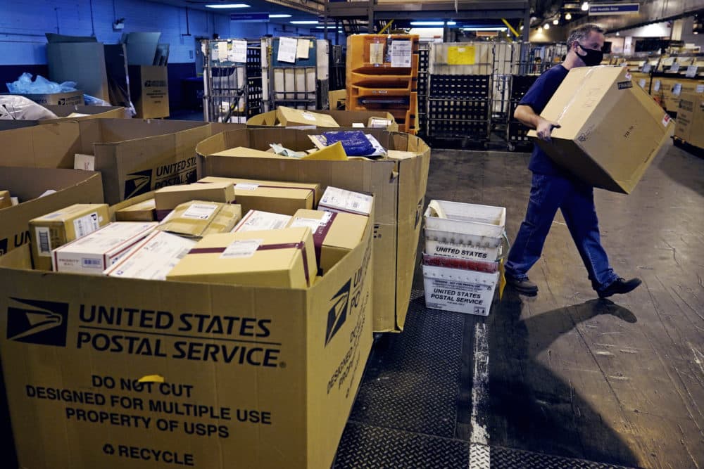 Workers unload packages and letters from mail trucks at the United States Postal Service sorting and processing facility, Thursday, Nov. 18, 2021, in Boston. Last year's holiday season was far from the most wonderful time of the year for the beleaguered U.S. Postal Service. Shippers are now gearing up for another holiday crush. (Charles Krupa/AP)