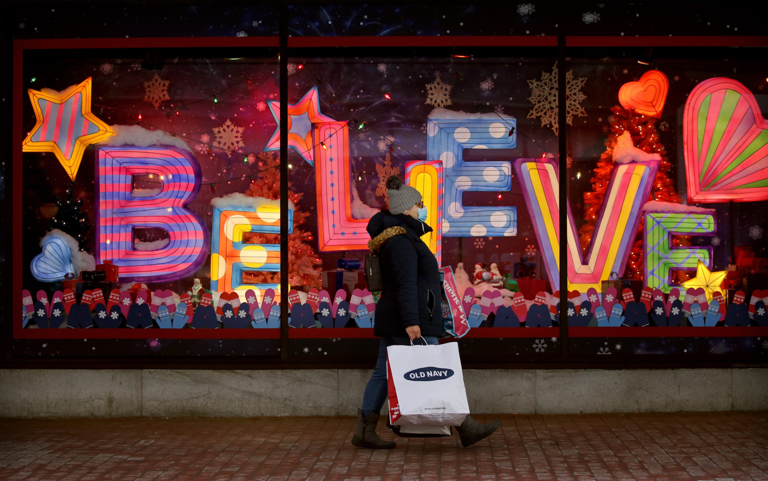 A shopper passes a Macy's store holiday window in Downtown Crossing in Boston in December 2020. (Craig F. Walker/The Boston Globe via Getty Images)