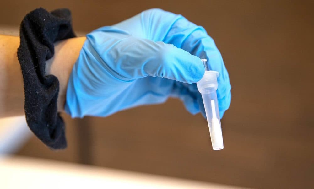 A rapid test vial containing a testing swab. (Robin Lubbock/WBUR)