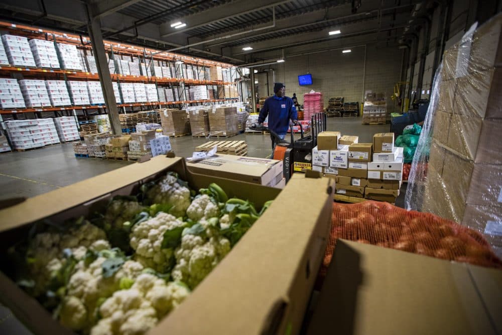 Greater Boston Food Bank warehouse associates move food to the loading dock to be distributed in July 2020. (Jesse Costa/WBUR)