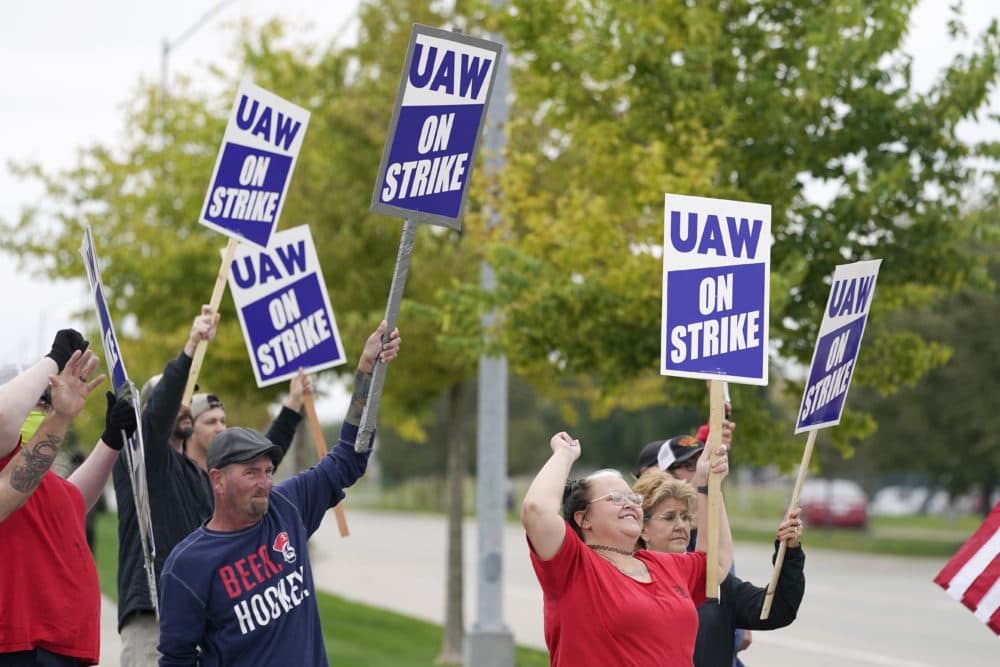 Members of the United Auto Workers strike outside of a John Deere plant, Wednesday, Oct. 20, 2021, in Ankeny, Iowa. About 10,000 UAW workers have gone on strike against John Deere since last Thursday at plants in Iowa, Illinois and Kansas. (Charlie Neibergall/AP)