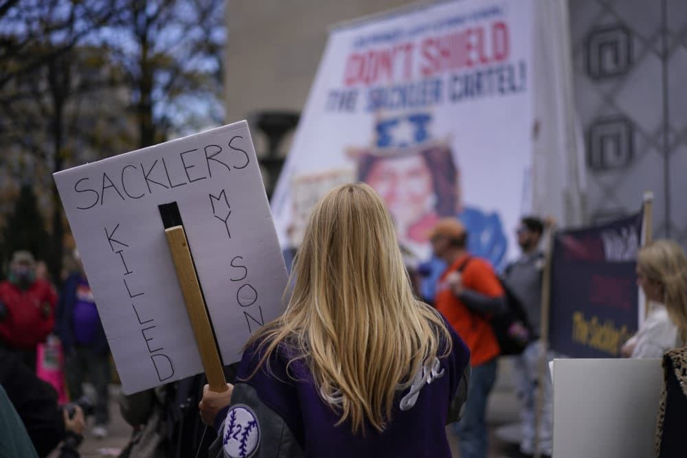 Jen Trejo from California holds a sign that reads &quot;SACKLERS KILLED MY SON&quot; during a protest with other advocates for opioid victims outside the Department of Justice, Dec. 3, 2021, in Washington. (Carolyn Kaster/AP)