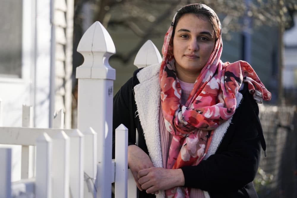 Haseena Niazi, a 24-year-old from Afghanistan, poses outside her home, Dec. 17, 2021, north of Boston. Niazi received a letter from the federal government denying her fiancé's humanitarian parole application earlier in the month.(Charles Krupa/AP)
