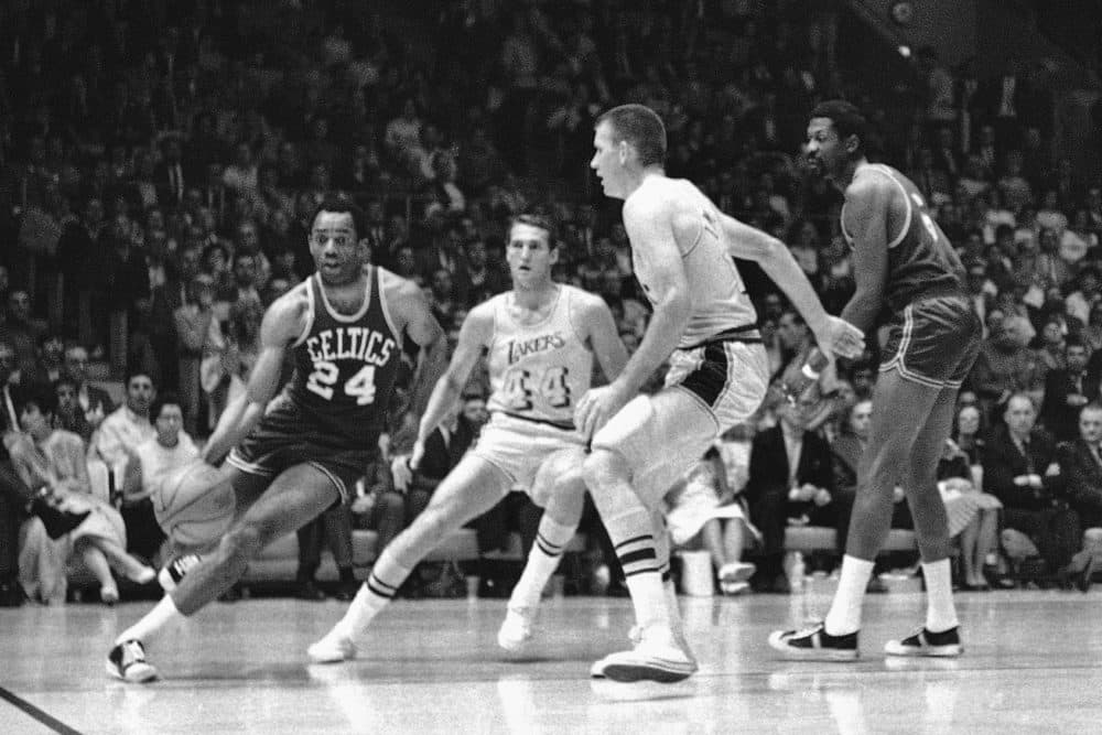 Boston's Sam Jones, left, drives past the Lakers' Jerry West (44) and drives along the baseline towards the basket in the teams' NBA playoff game in Los Angeles on May 2, 1968. (AP file photo)