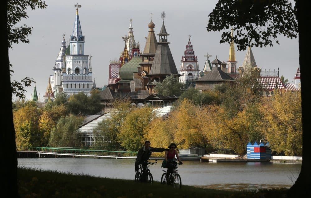 A couple ride their bicycles during an autumn day in Moscow's Izmaylovsky Park, Russia, Thursday, Sept. 27, 2012. An exhibition and entertainment complex imitating the architecture of old Russian churches and palaces is seen in the background. (Mikhail Metzel/AP)