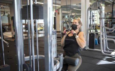 Christa Ellis lifts weights at Healthworks on Stuart Street. (Robin Lubbock/WBUR)