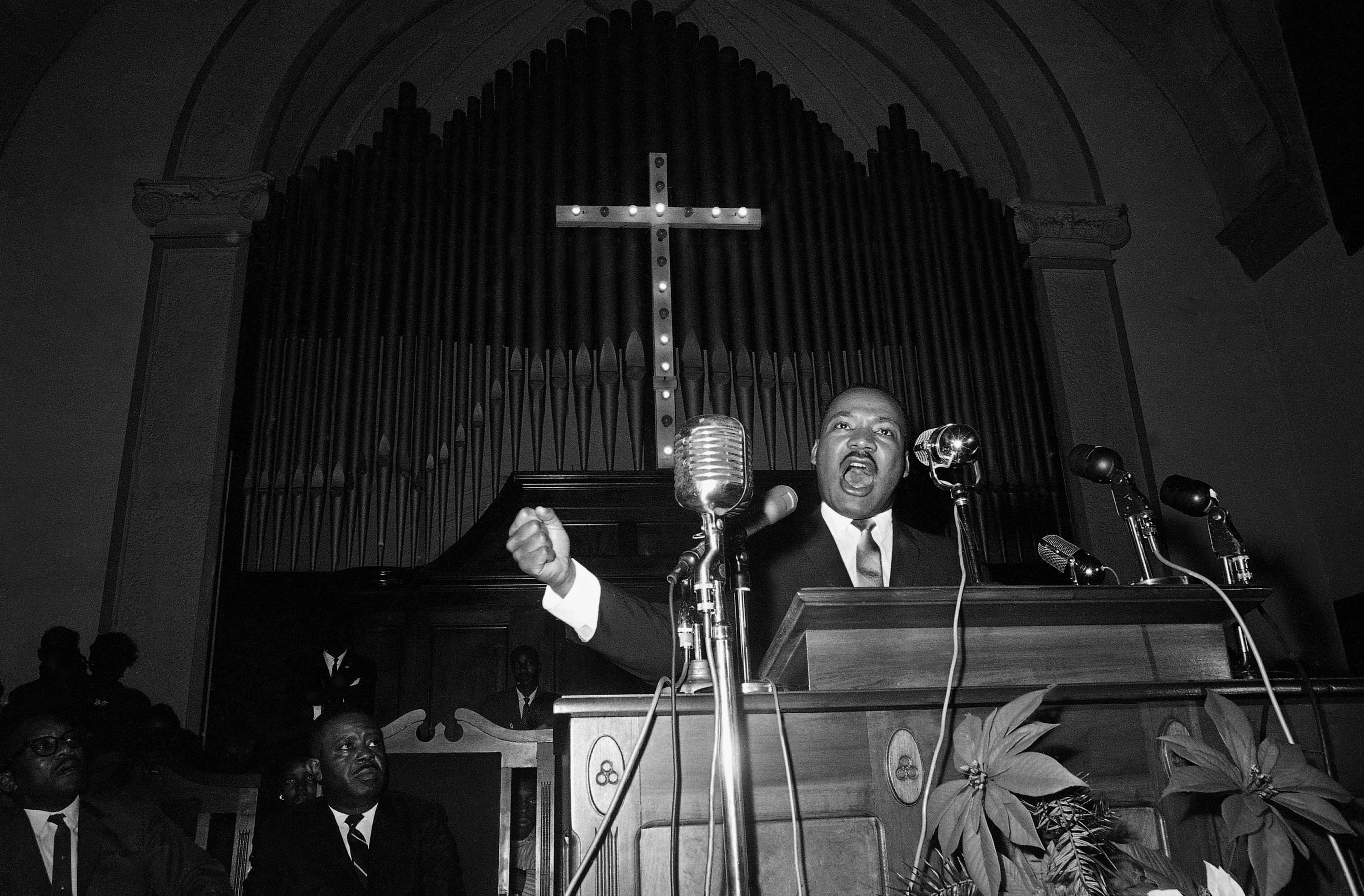 Martin Luther King Jr. speaks to a wildly cheering crowd of supporters on Jan. 2, 1965, in Selma, Ala. King was calling for a new voter registration drive throughout Alabama and promising to &quot;march on the ballot boxes&quot; unless African American are given the right to vote. (Horace Cort/AP)