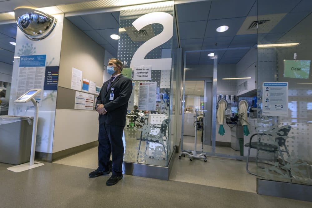 Security officer John Wood stands watch in the triage area of the emergency department at Mass General Hospital. (Jesse Costa/WBUR)