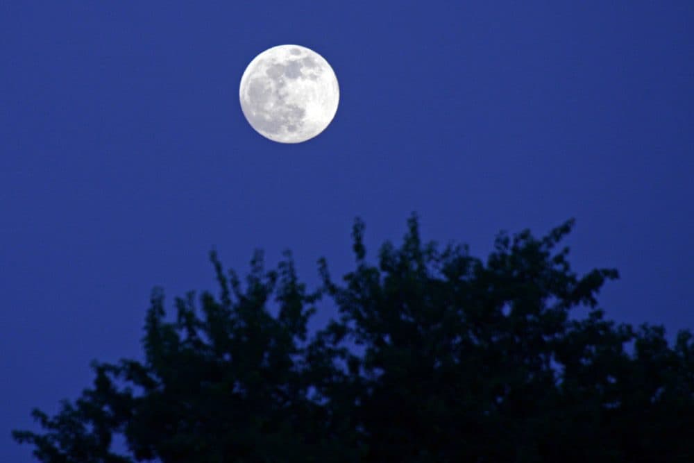 The full moon rises in the skyline of Siliguri on Dec. 18, 2021. (Diptendu DUTTA/AFP via Getty Images)