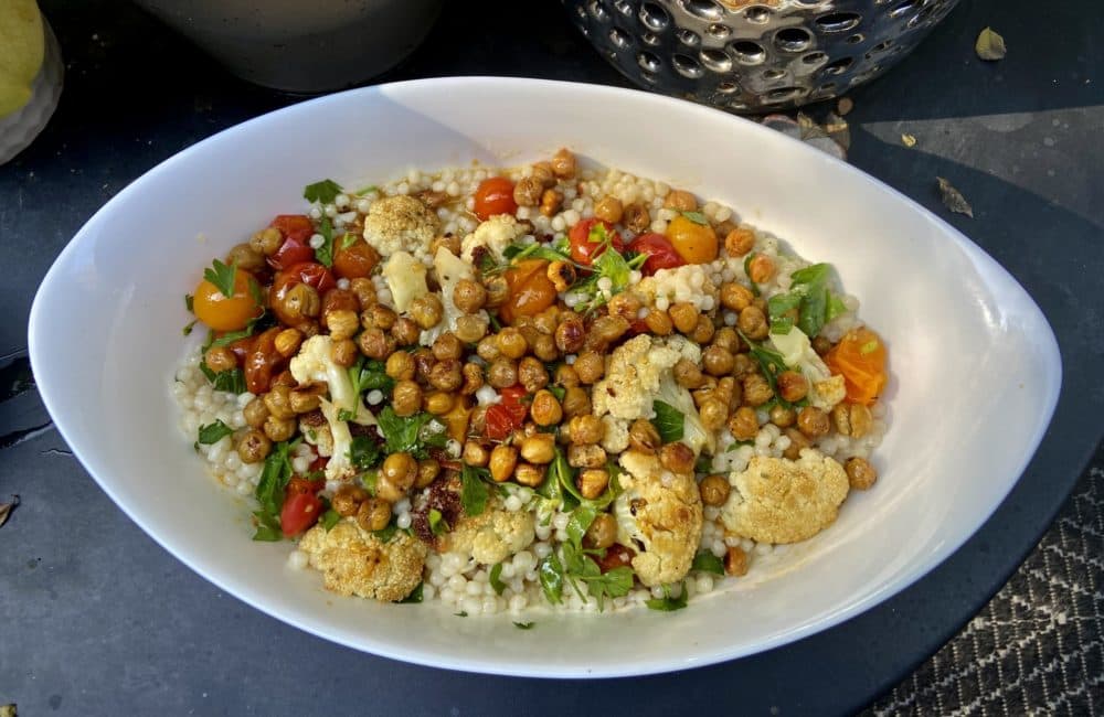 Roasted cauliflower and cherry tomatoes with Israeli couscous and crispy spiced chickpeas. (Kathy Gunst/Here & Now)