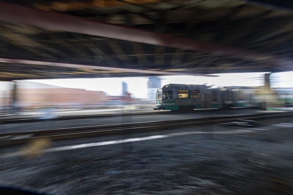 An MBTA Green Line train rides on the tracks beneath McGrath Highway in Somerville during a test run of the new extension service. (Jesse Costa/WBUR)