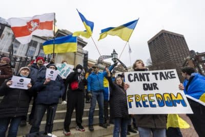 About one hundred people gathered in front of the State House for a rally to support Ukraine. (Jesse Costa/WBUR)