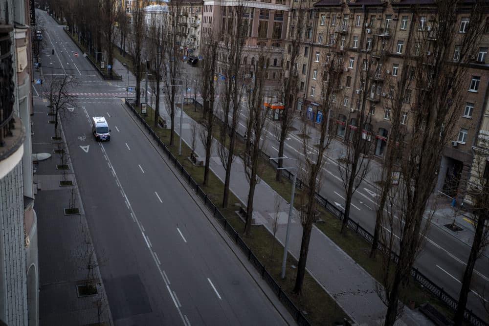 An emergency vehicle drives on an empty street during a curfew in the central of Kyiv, Ukraine, Sunday, Feb. 27, 2022. A Ukrainian official says street fighting has broken out in Ukraine's second-largest city of Kharkiv. Russian troops also put increasing pressure on strategic ports in the country's south following a wave of attacks on airfields and fuel facilities elsewhere that appeared to mark a new phase of Russia's invasion. (Emilio Morenatti/AP)