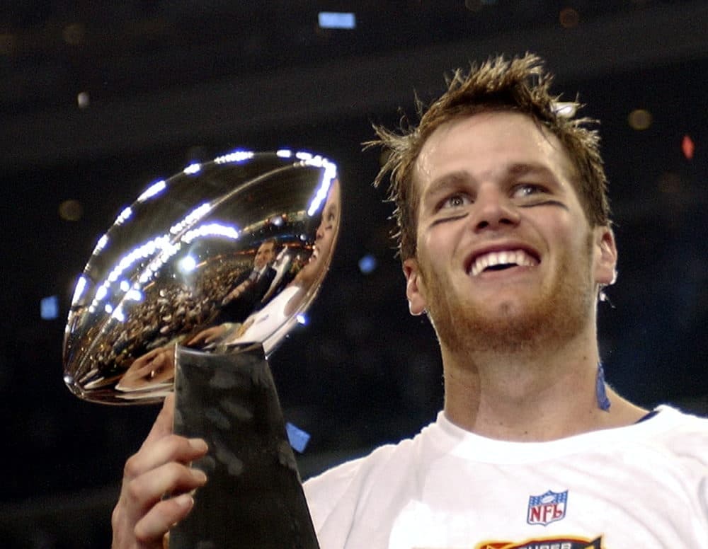 FILE - New England Patriots quarterback Tom Brady holds the Vince Lombardi Trophy after the Patriots beat the Carolina Panthers 32-29 in Super Bowl XXXVIII in Houston, Feb. 1, 2004. (Dave Martin/AP File)
