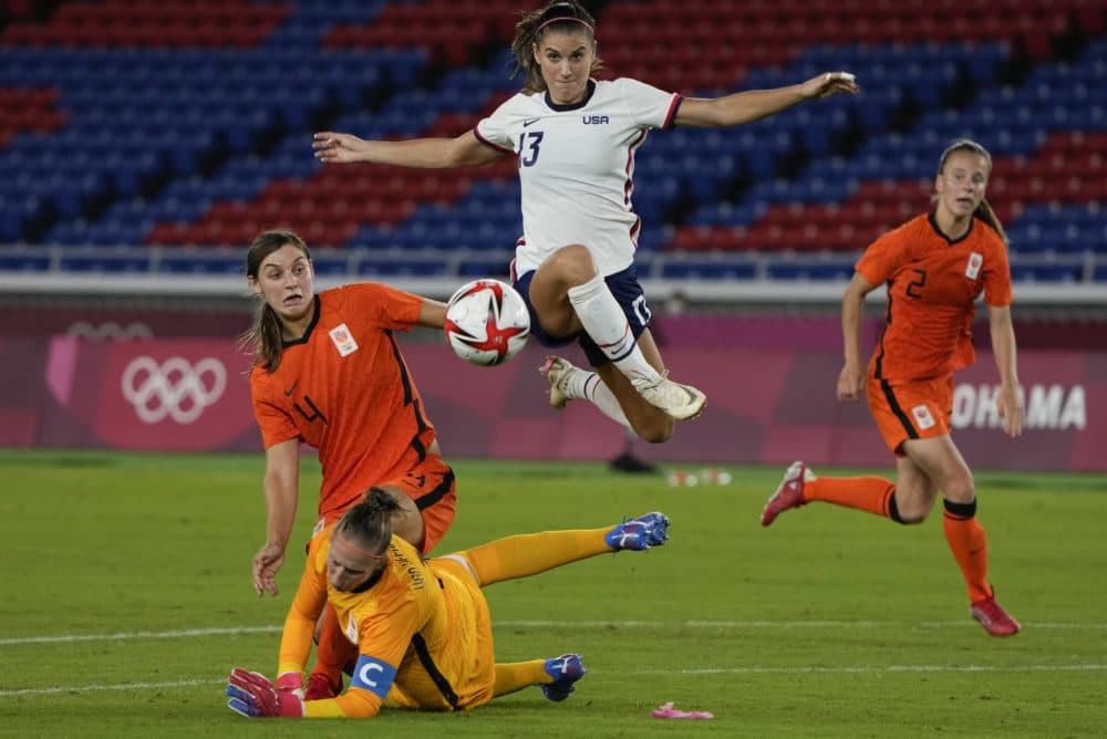 United States' Alex Morgan jumps over Netherlands' goalkeeper Sari van Veenendaal as she attempts to score during a women's quarterfinal soccer match at the 2020 Summer Olympics on July 30, 2021. (Kiichiro Sato/AP)