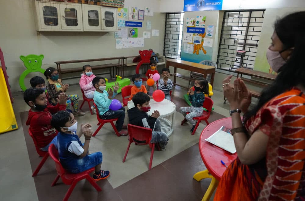 Children wearing face masks as a precaution against the coronavirus attend a pre-school in Ahmedabad, India, Thursday, Feb. 17, 2022. Pre schools in Gujarat state reopened Thursday after two years following decline in number of COVID-19 cases. (AP Photo/Ajit Solanki)