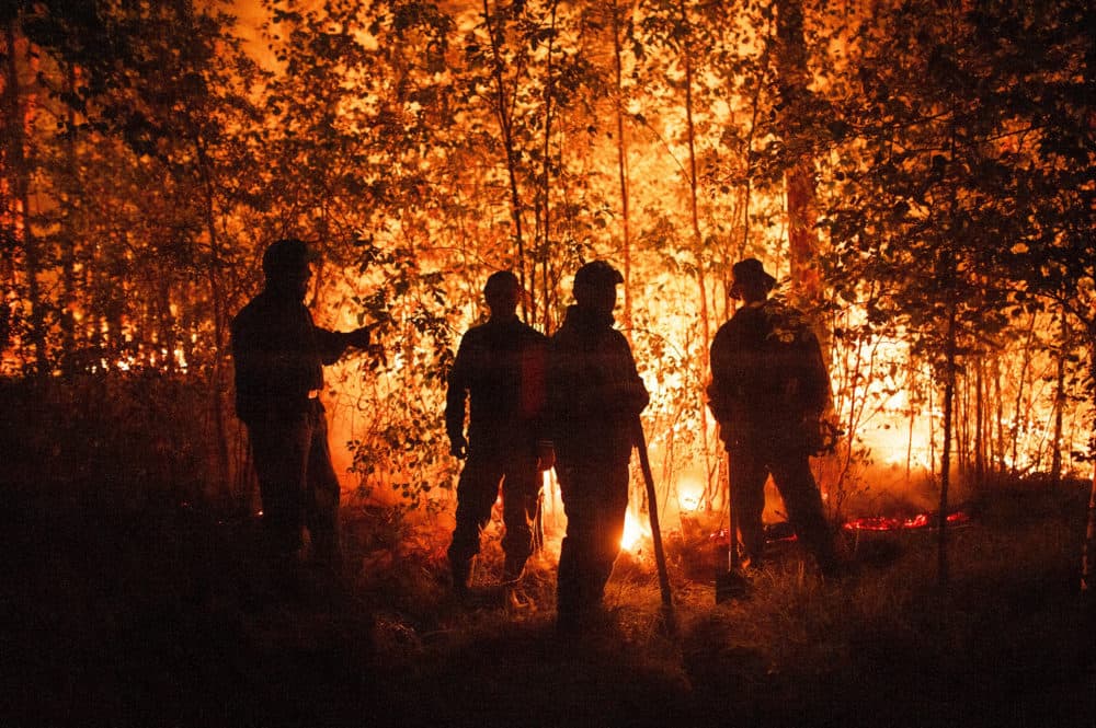 Firefighters work at the scene of forest fire near Kyuyorelyakh village at Gorny Ulus area, west of Yakutsk, in Russia Thursday, Aug. 5, 2021. (Ivan Nikiforov/AP)