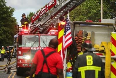 Boston firefighters on the scene of a fire in South Boston in May 2020. (John Tlumacki/The Boston Globe via Getty Images)