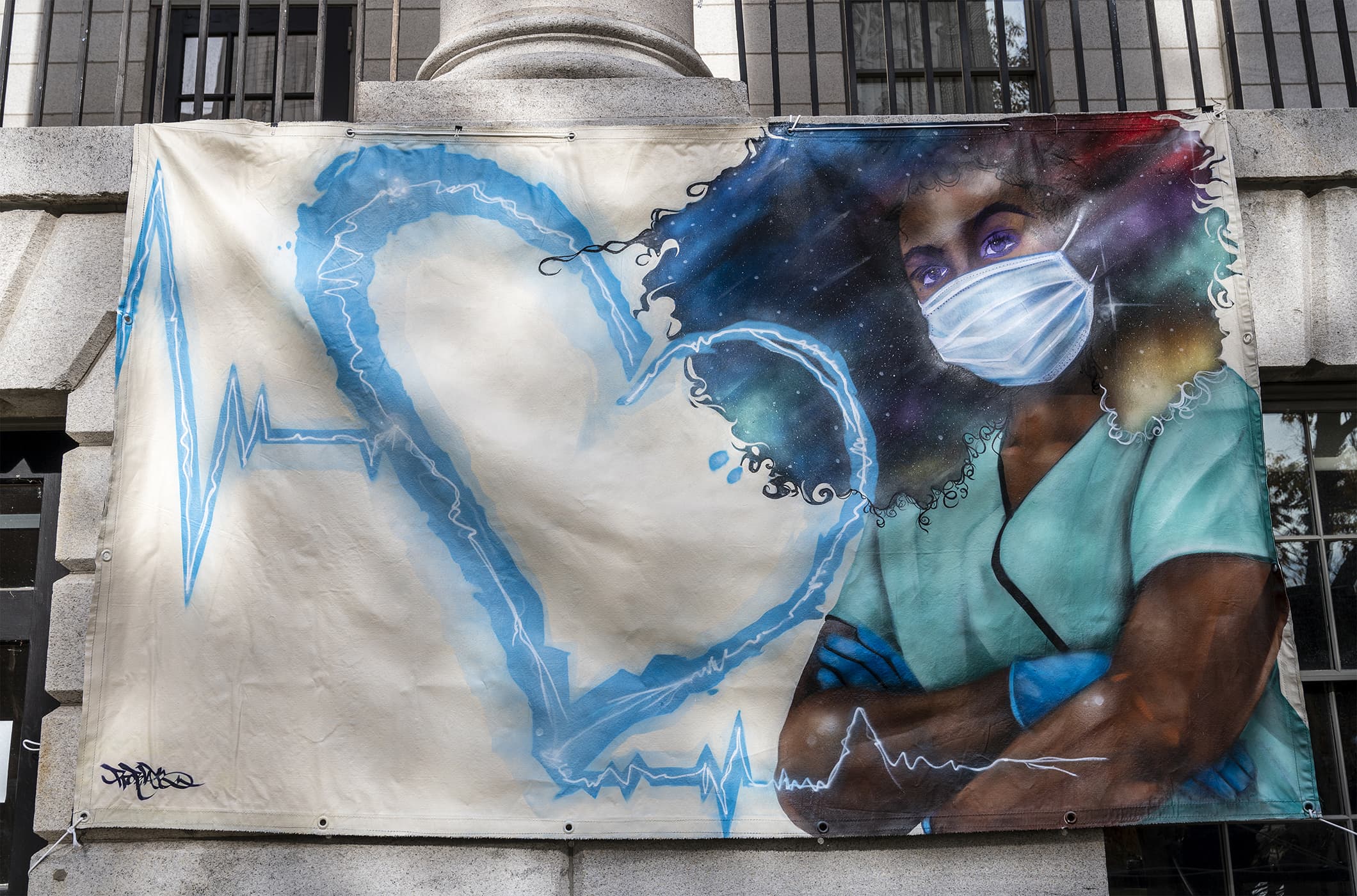 “Peoples’ heART Project” mural, spray paint on canvas, by Rob “ProBlak” Gibbs, at its unveiling on the MGH Bulfinch lawn, before it was exhibited indoors. (Photo by Eleni Balasalle)