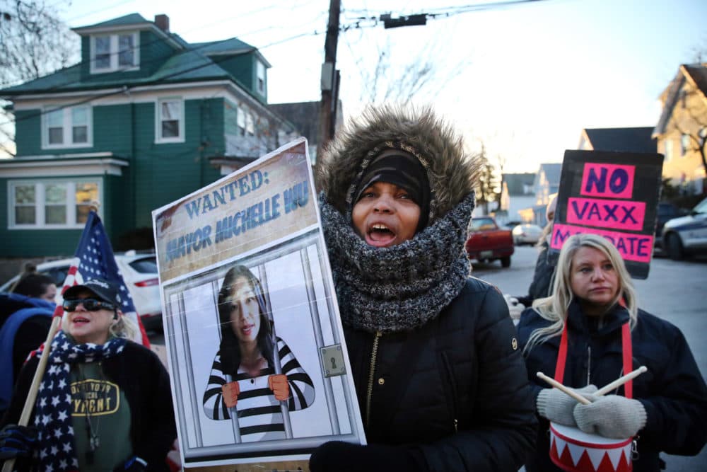 A group of demonstrators yell outside the home of Boston Mayor Michelle Wu in on Jan. 25. The group was protesting the vaccine mandate in Boston. (Craig F. Walker/The Boston Globe via Getty Images)