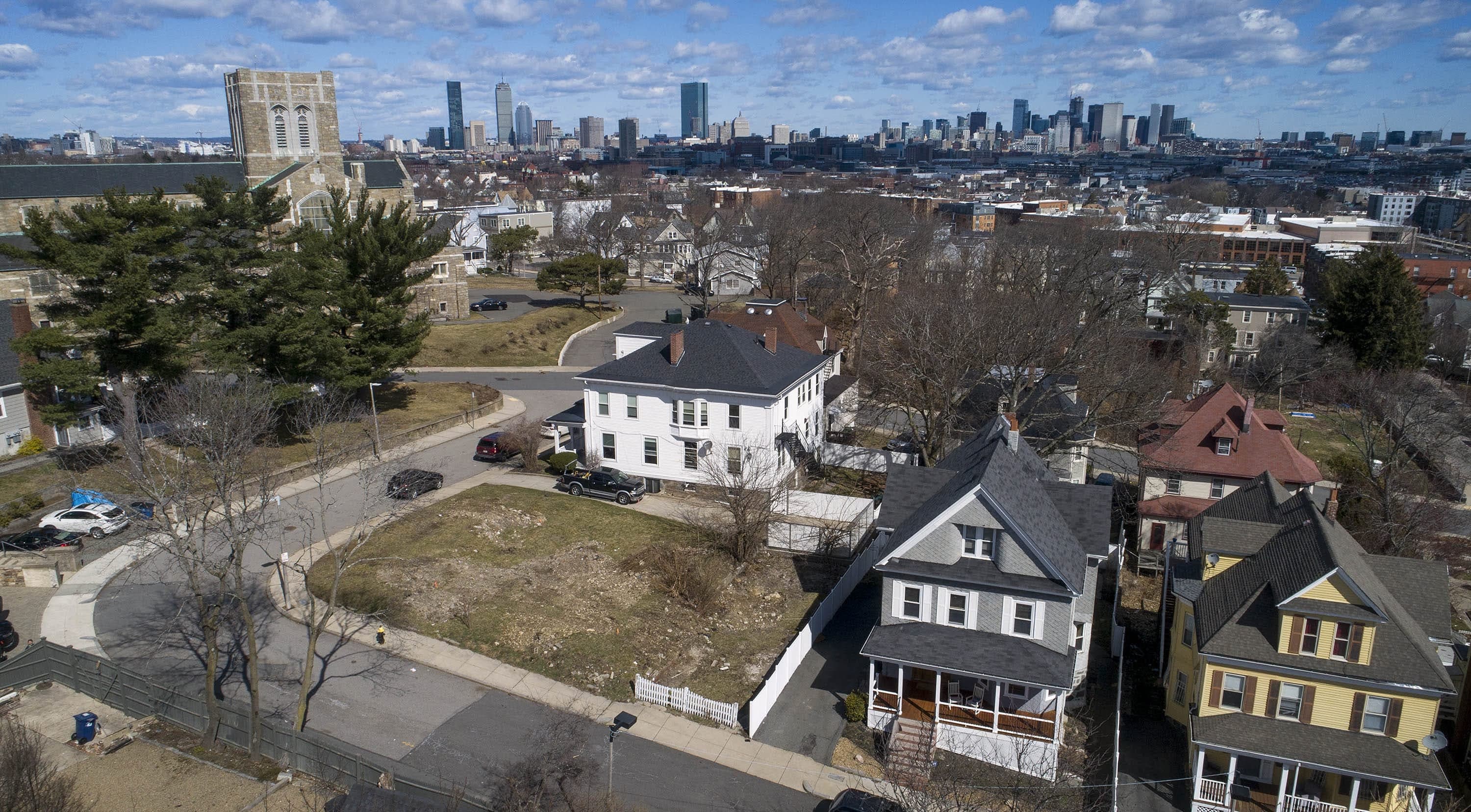 The lot at 7 Half Moon Street in Roxbury will be the site of two new dwellings in the Dudley Street Neighborhood Initiative's plan. (Robin Lubbock/WBUR)
