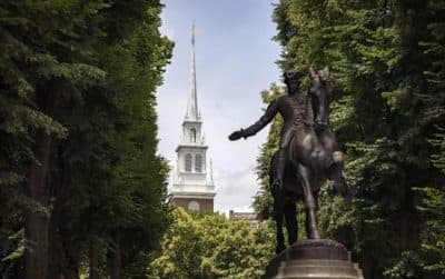 A statue of Paul Revere in front of the Old North Church bell tower in Boston's North End. The photo was taken by Robin Lubbock for WBUR.