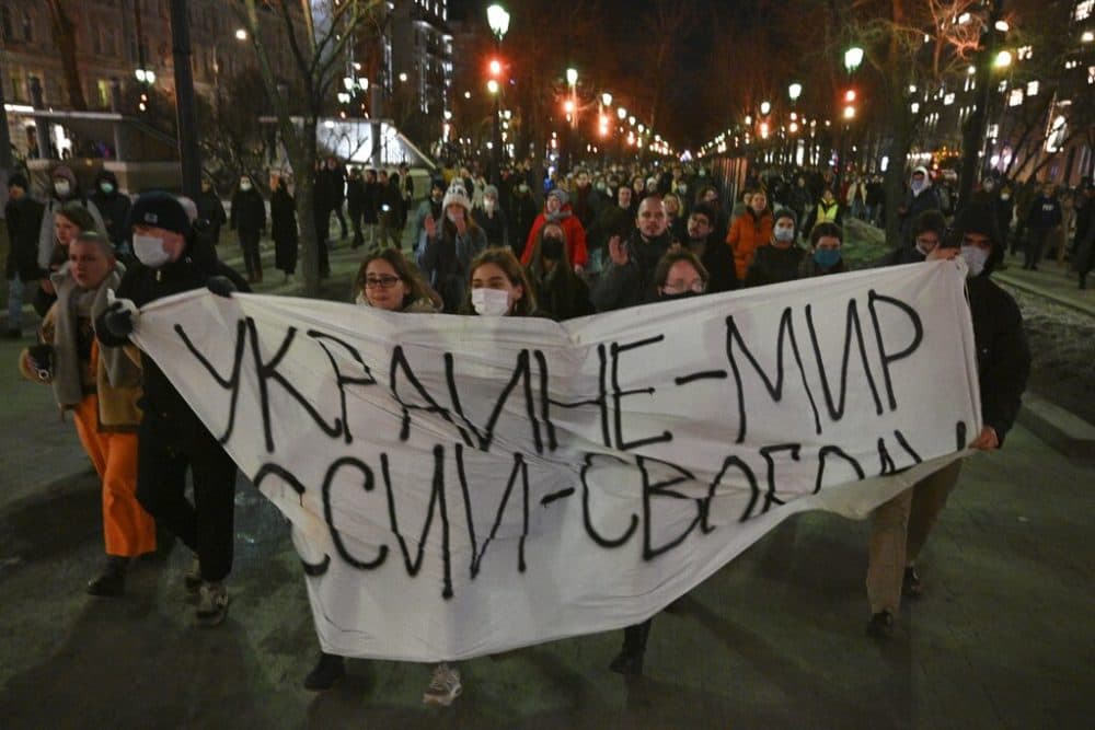 Demonstrators march with a banner that reads: &quot;Ukraine - Peace, Russia - Freedom,&quot; in Moscow, Russia, Thursday, Feb. 24. (Dmitry Serebryakov/AP Photo)